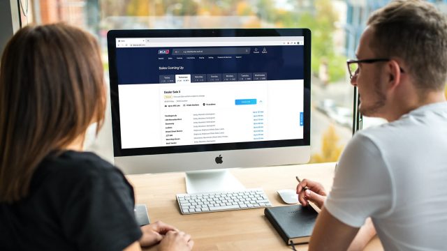BCA computer screen and two people stock image