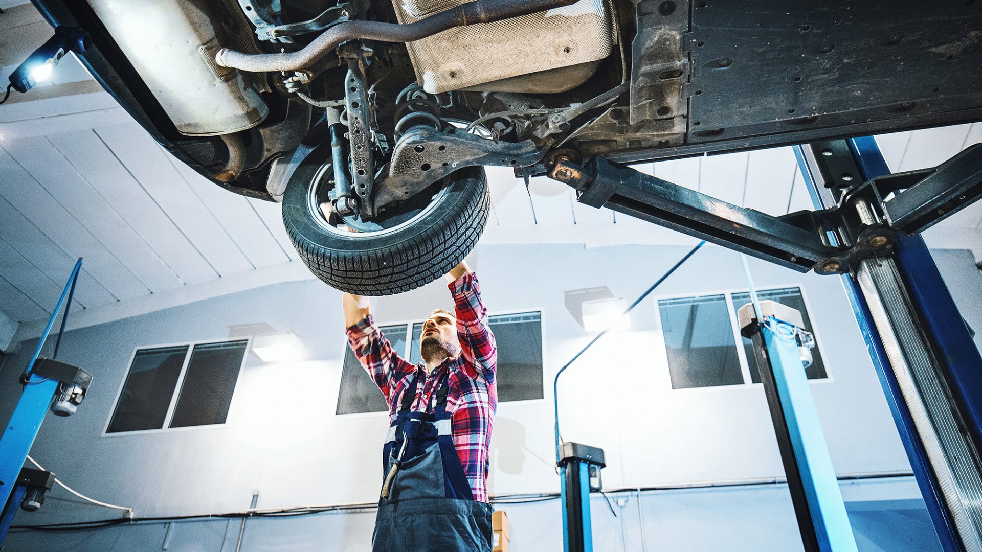 Mechanic working on wheel via iStock-504343604