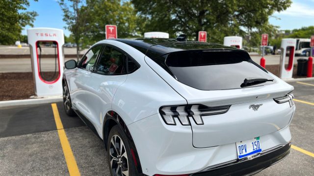 Ford Mustang Mach-e charing at Tesla supercharger